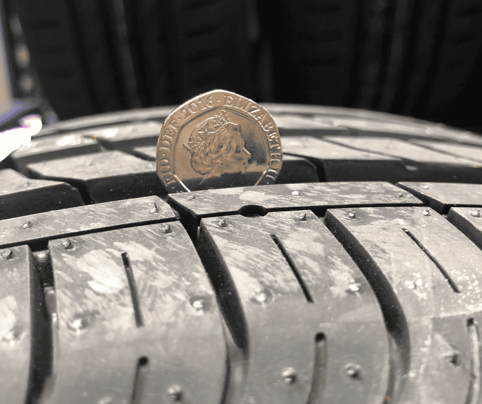 Checking the tyre tread with a 20p 