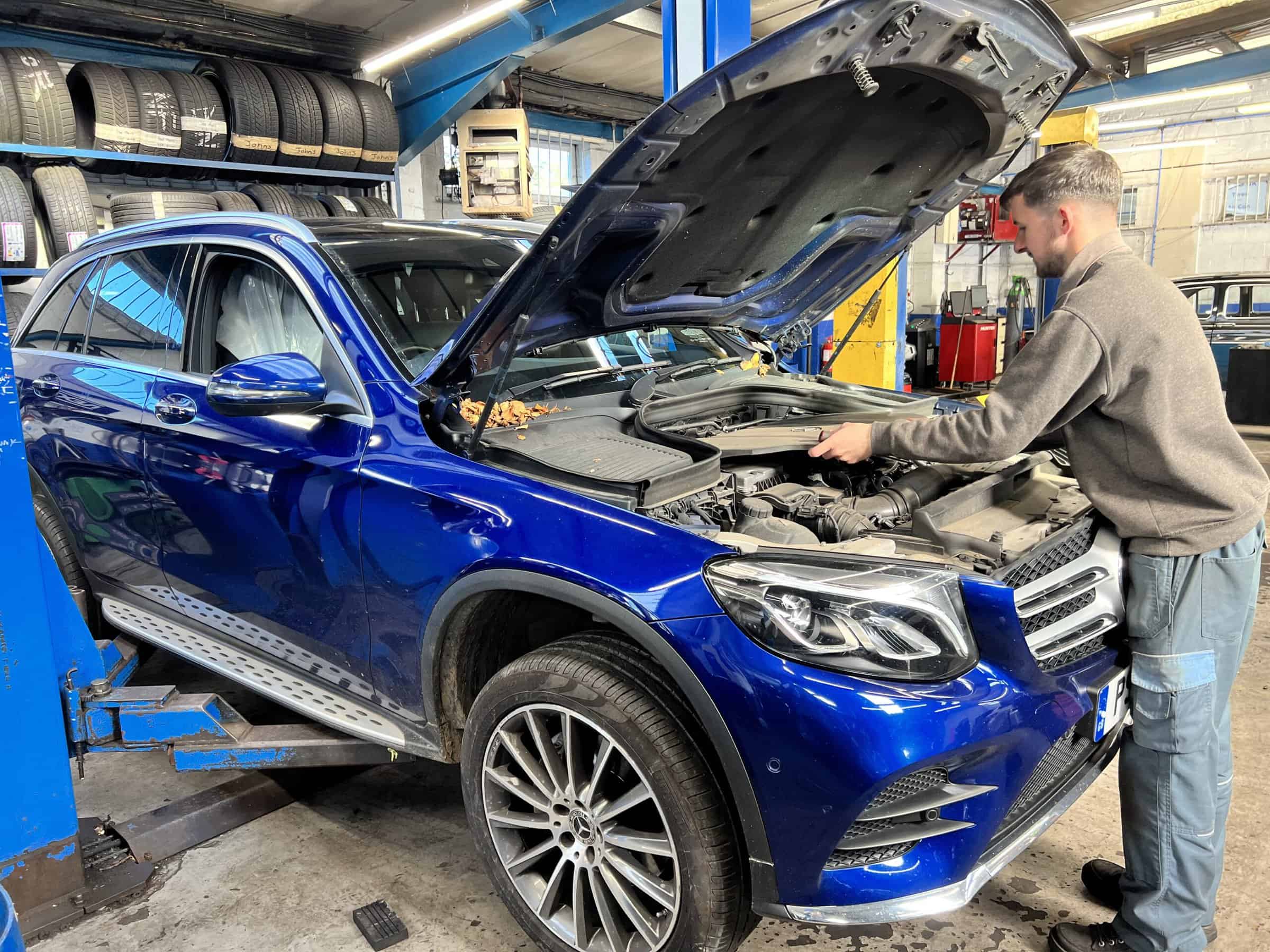 Technician conducting Prestige Vehicle Servicing with Precision